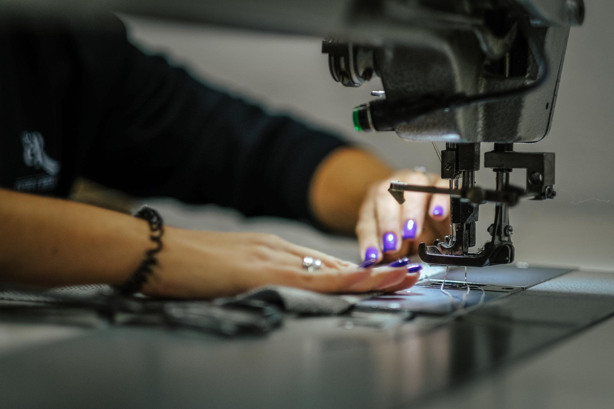 embroidery workshop with technician adjusting machine