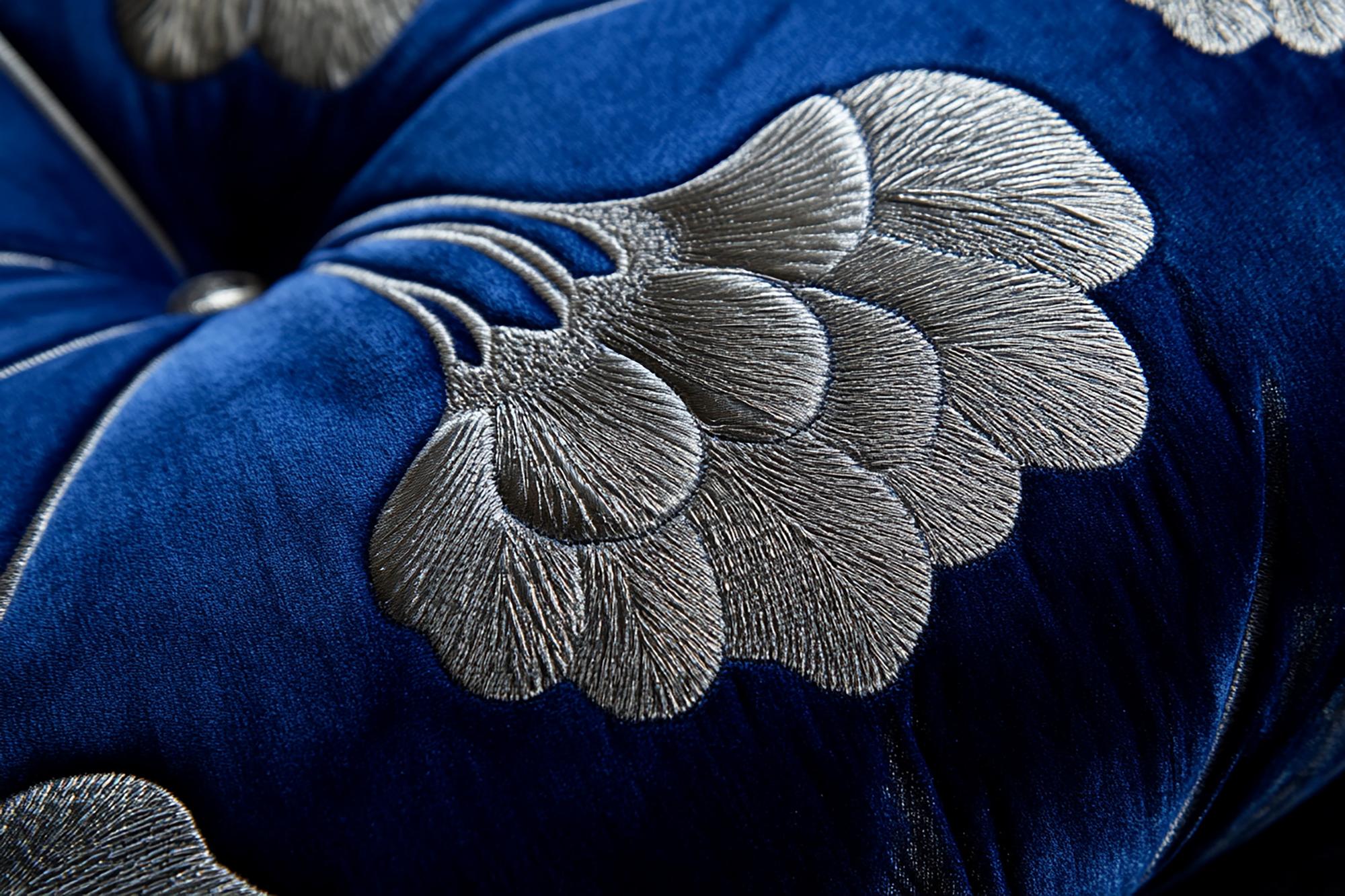 close-up of blue and silver embroidery on dark fabric